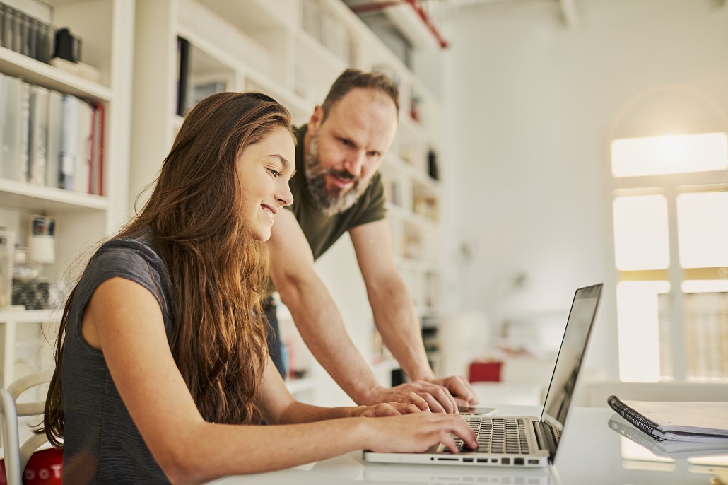 Father and daughter learning about college essays