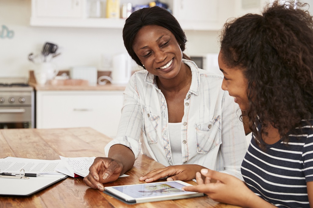 Mother and daughter using laptop to learn about loan certification