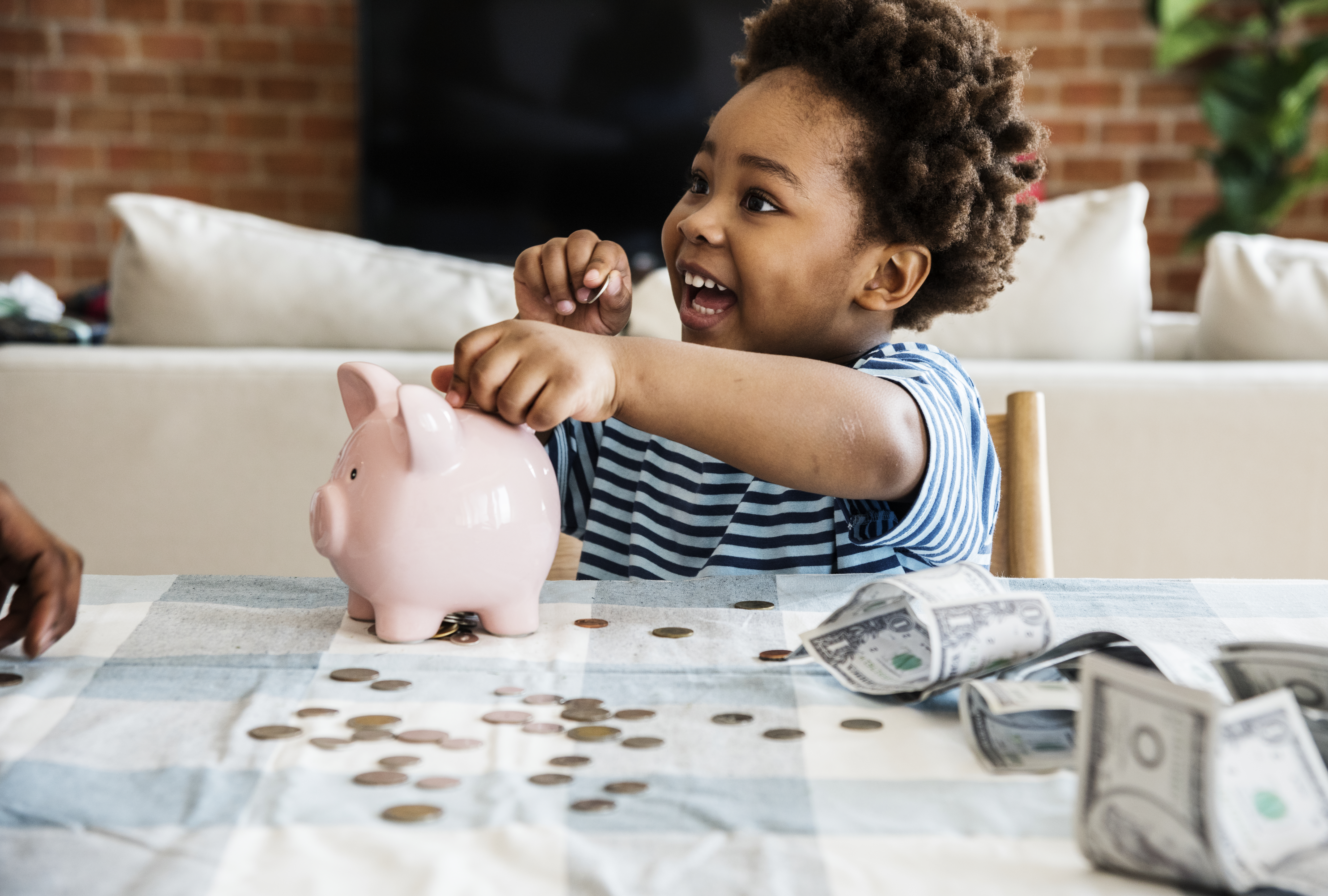 A young student using a piggy bank to save for college