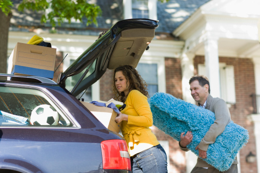 A family helping a student move into their college dorm