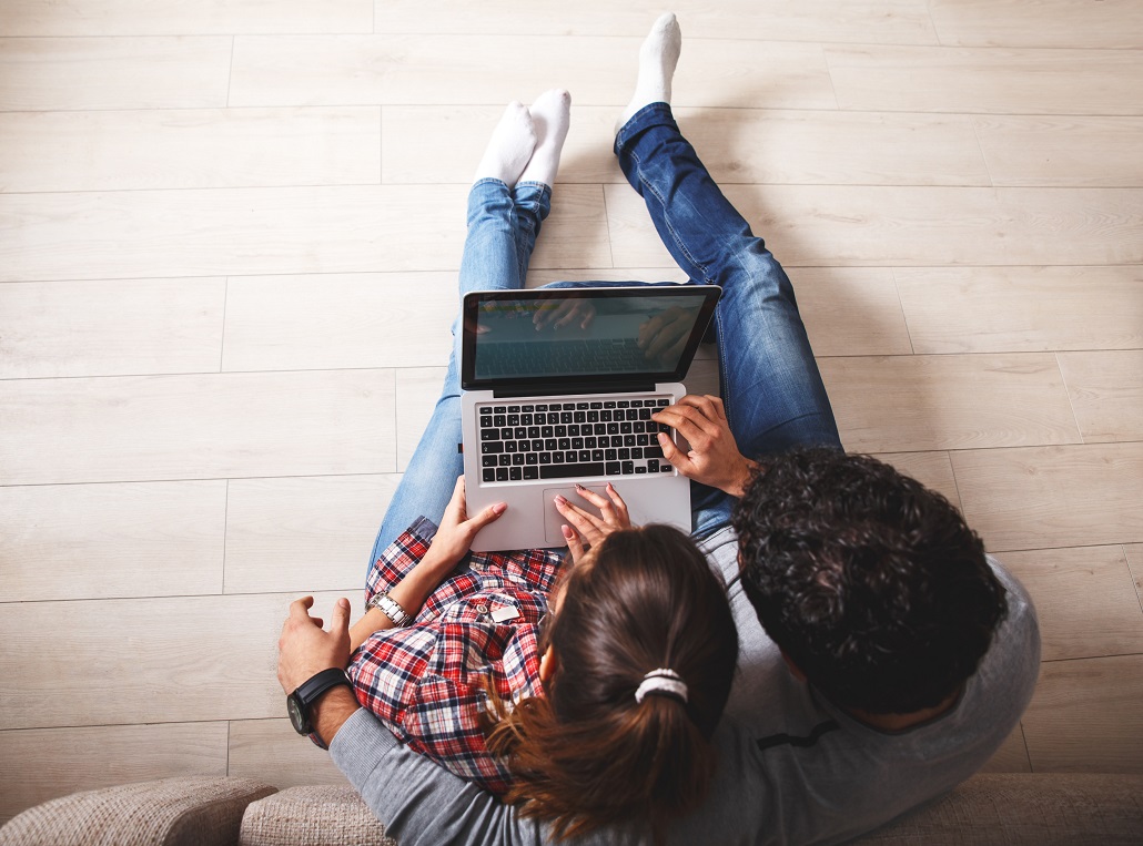 Couple working on laptop to get answers to financial aid questions