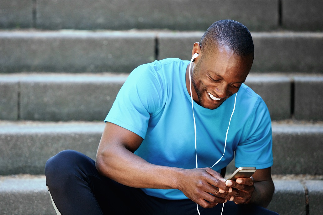 man using phone to save for college