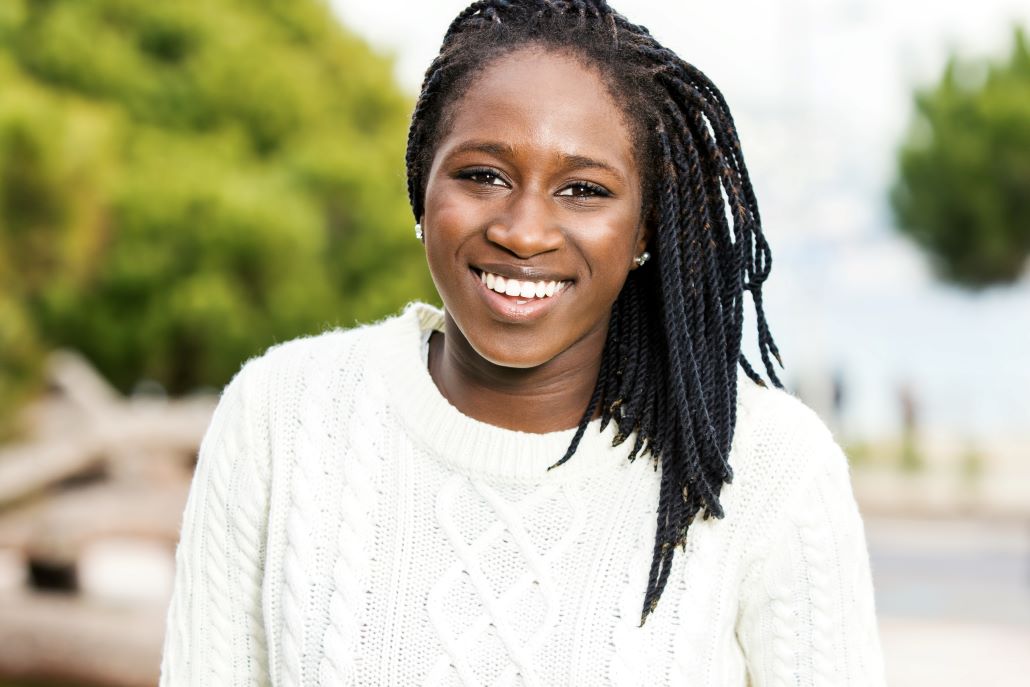 Young smiling woman standing outside