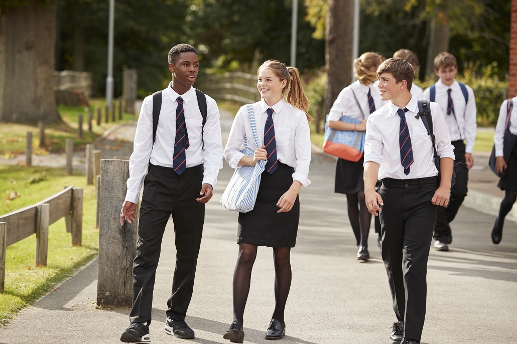 Students walking outside talking about private scholarships