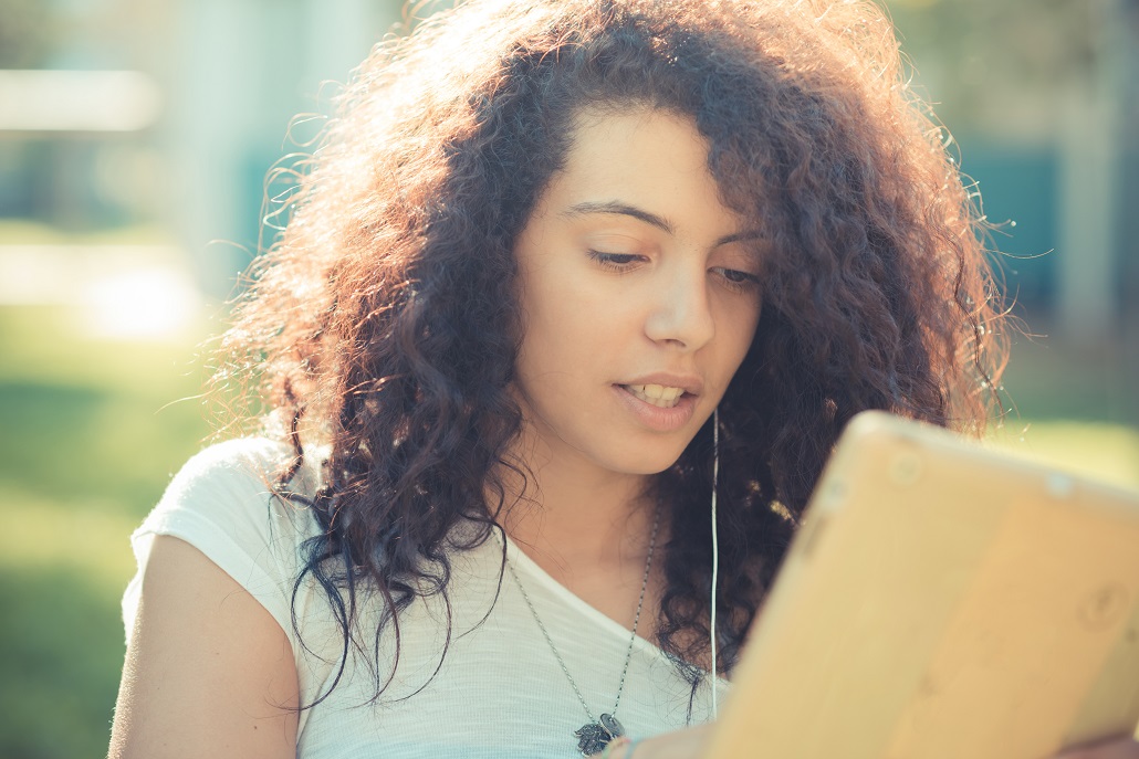 Student reading about College Board Opportunity Scholarships on a tablet