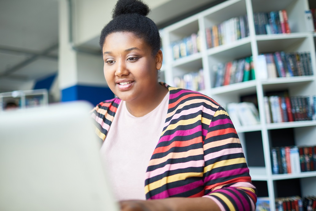 Woman using computer to learn about student loan repayment