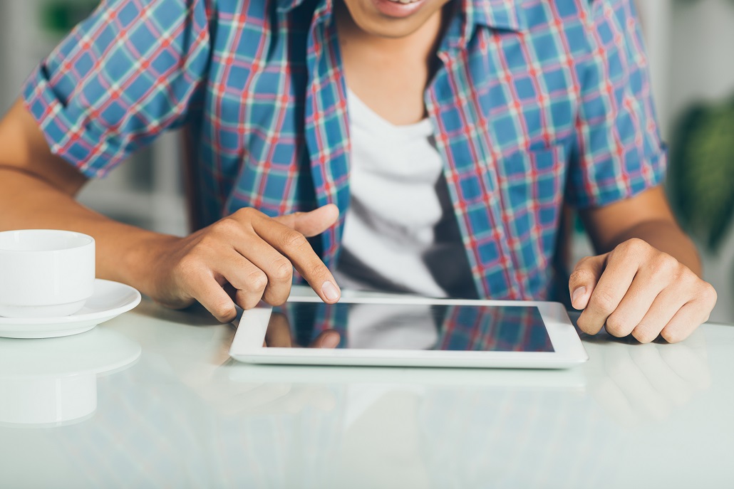 Person using tablet to pay student loans