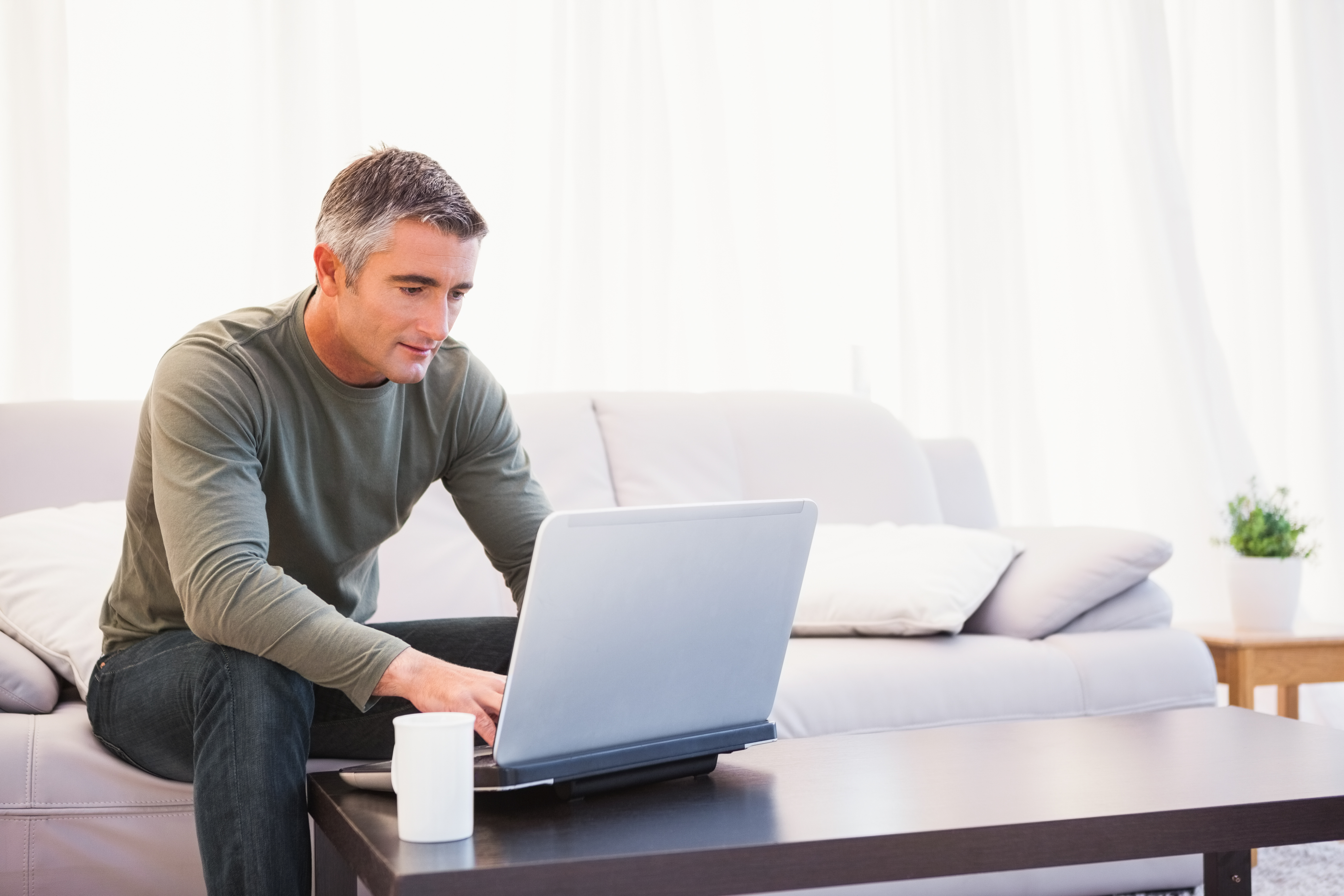 Man using laptop to learn about the U.Plan and U.Fund