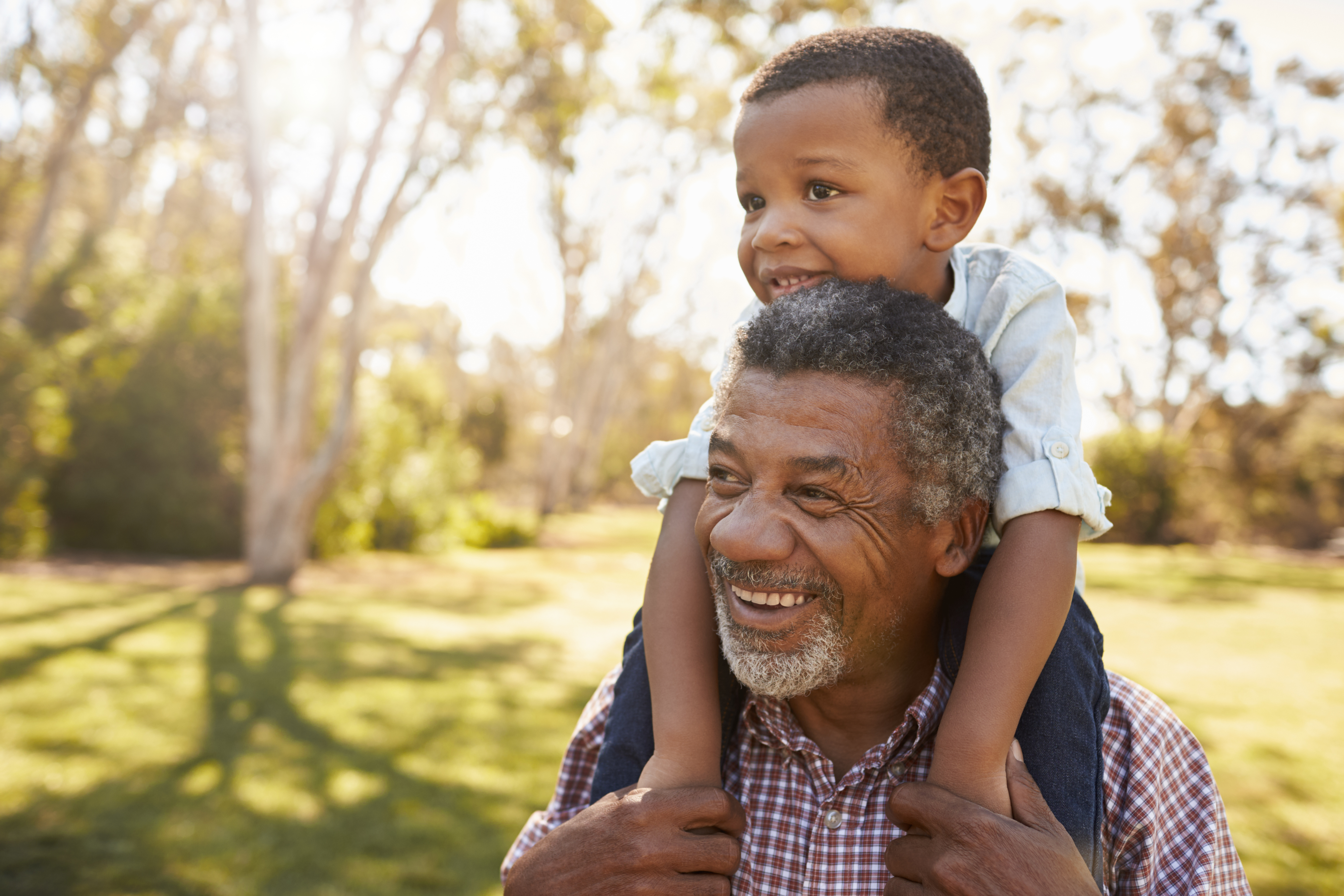 A grandfather giving a grandchild a piggyback ride