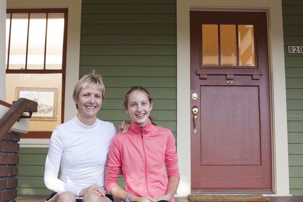 Mother and daughter sitting on stairs talking about saving for college