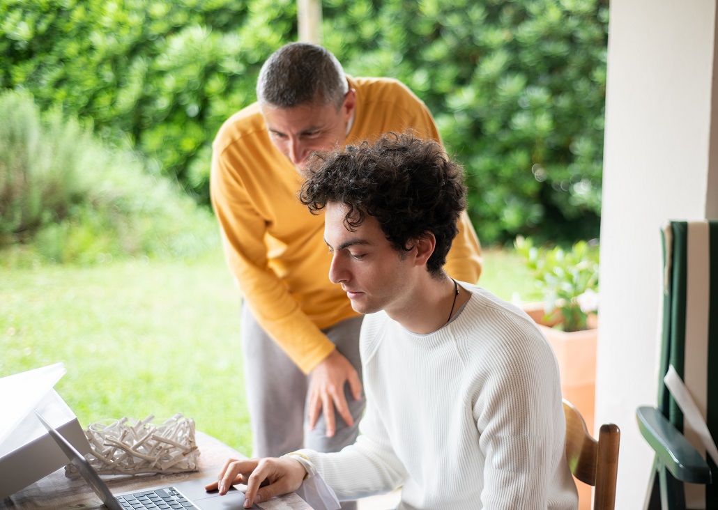 Father and son learning why to apply for financial aid