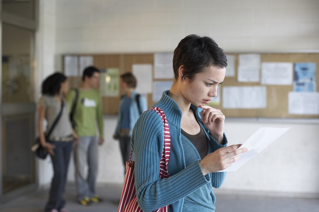 Student looking at letter