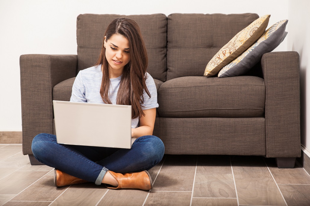 Woman sitting on floor using laptop