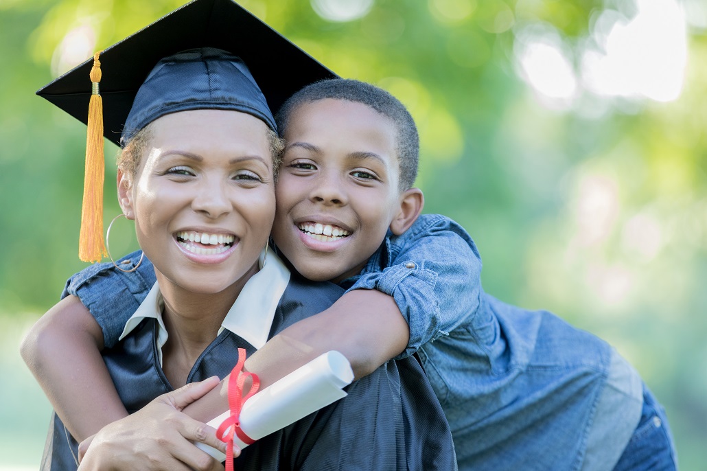 Woman graduating college after receiving scholarship for adult learner