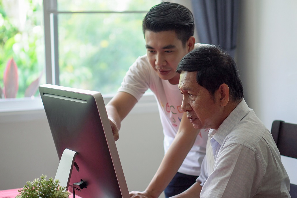 Father and son completing the FAFSA on a computer