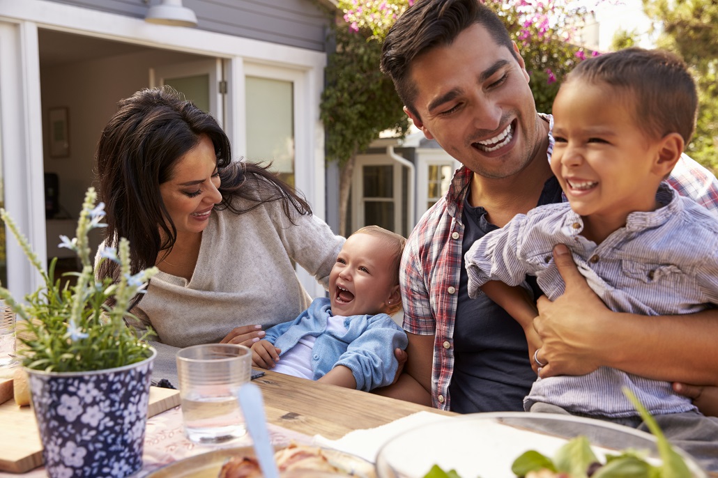 Family of four sitting at a table outside 