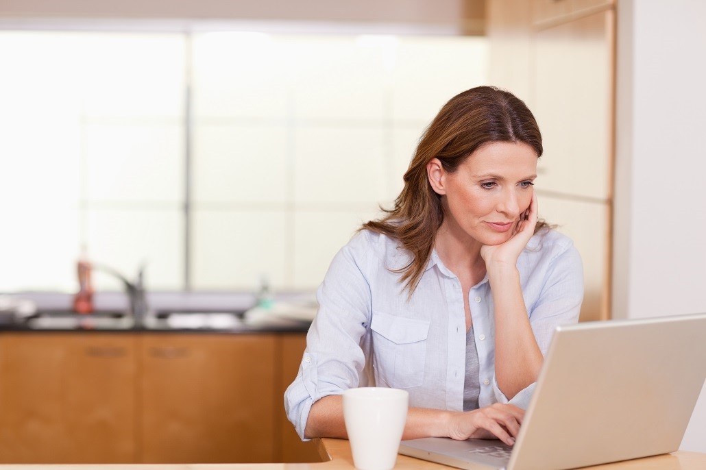 A woman reading about borrowing a MEFA Loan on a laptop
