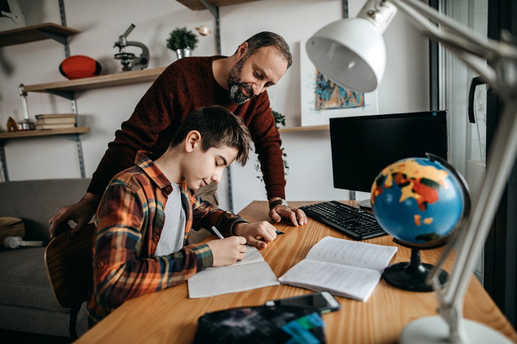 Father and son using computer to save for college