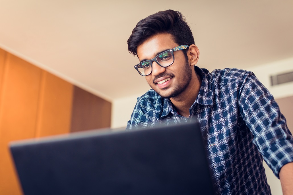 Man using computer to learn about student loan refinancing