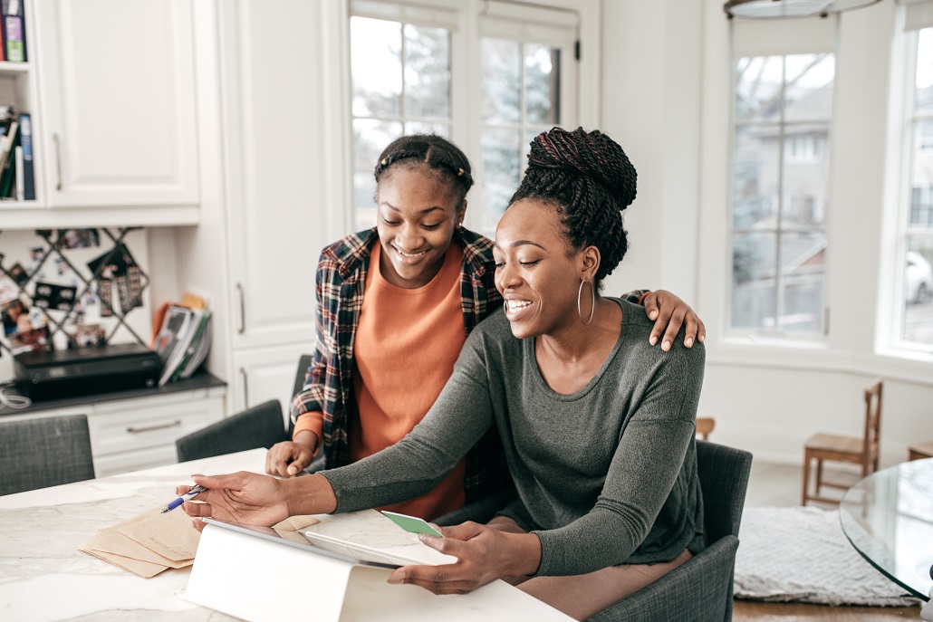Mother and daughter reviewing tips for borrowing college loans
