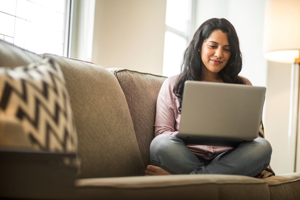 Woman using laptop after going back to college
