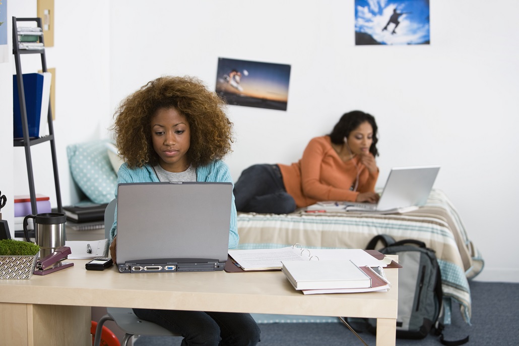 College student using computer to read tips to save money