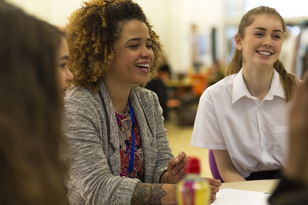 A school counselor speaking with students