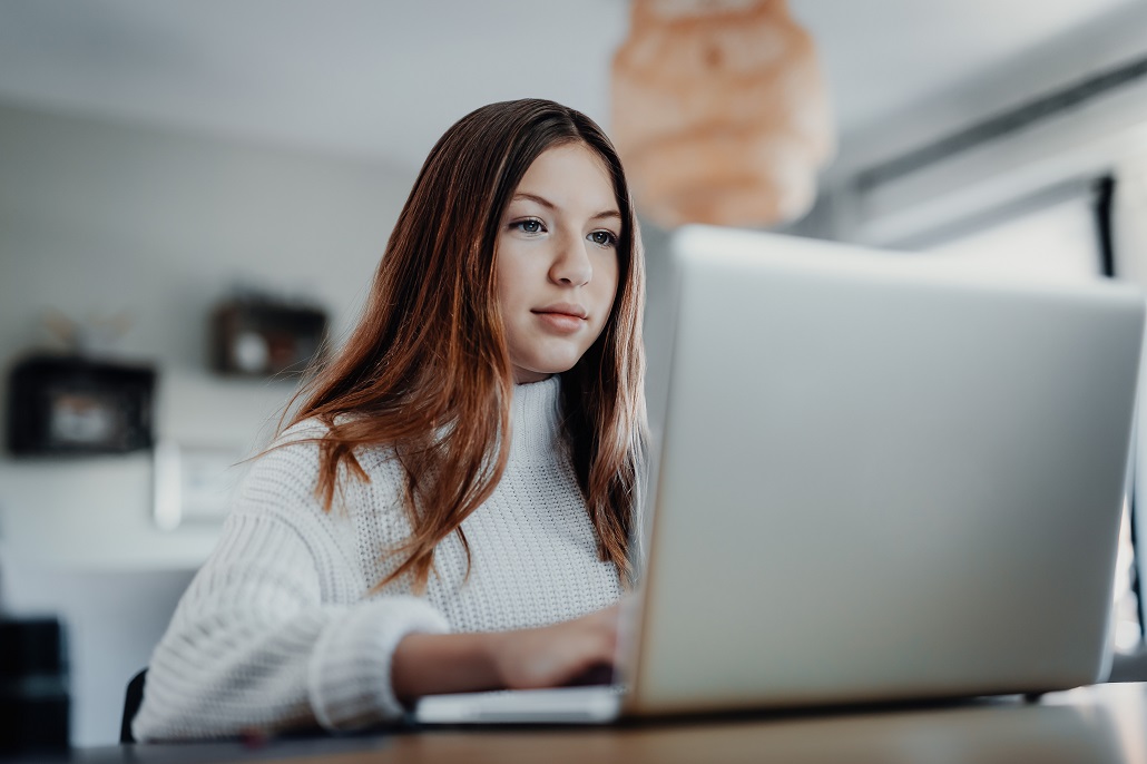 Student using laptop to learn how to apply to college