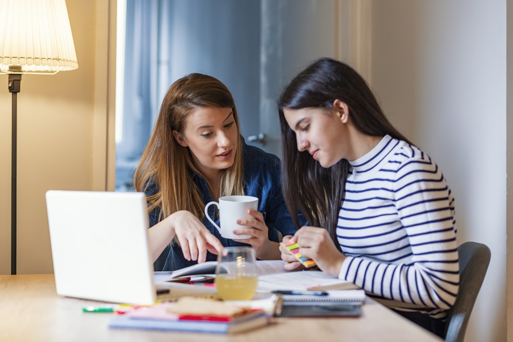 Mother and daughter using computer to review transition to college