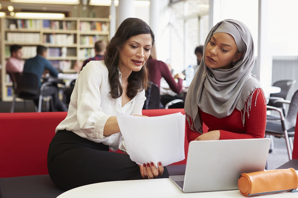 Woman speaking to student about One Family