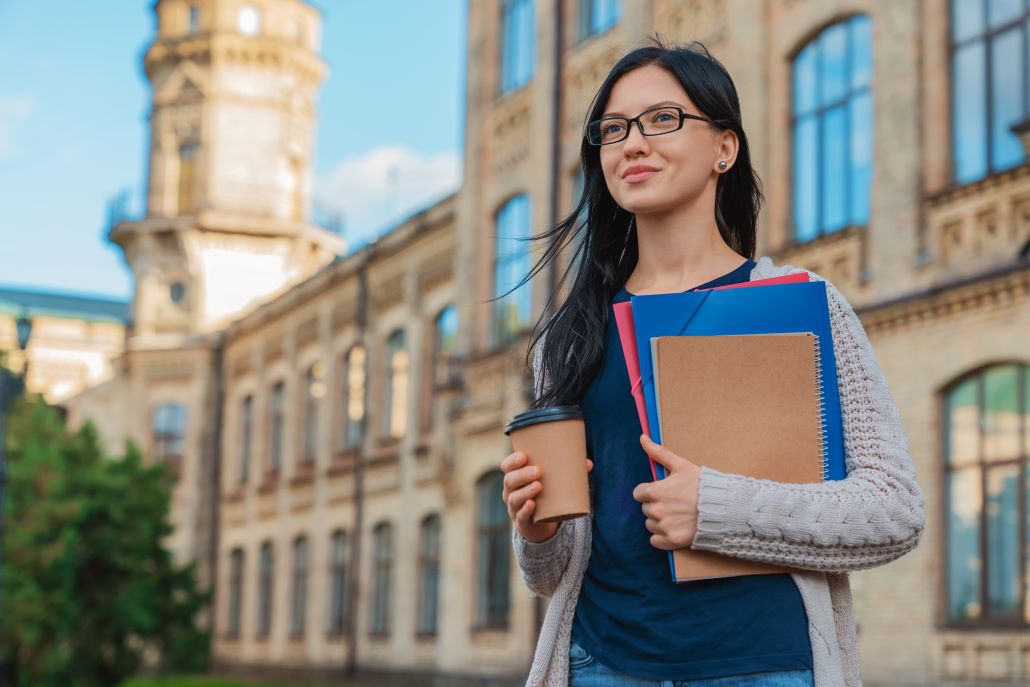 Female college student walking on campus planning how to prepare for next year
