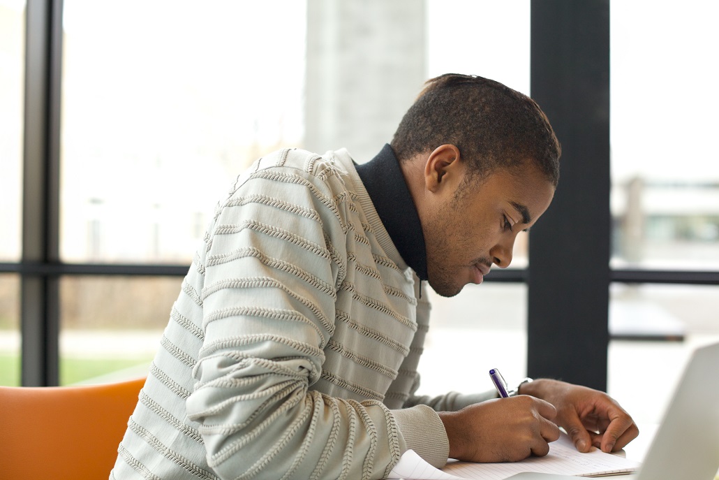 Student using laptop to research scholarships