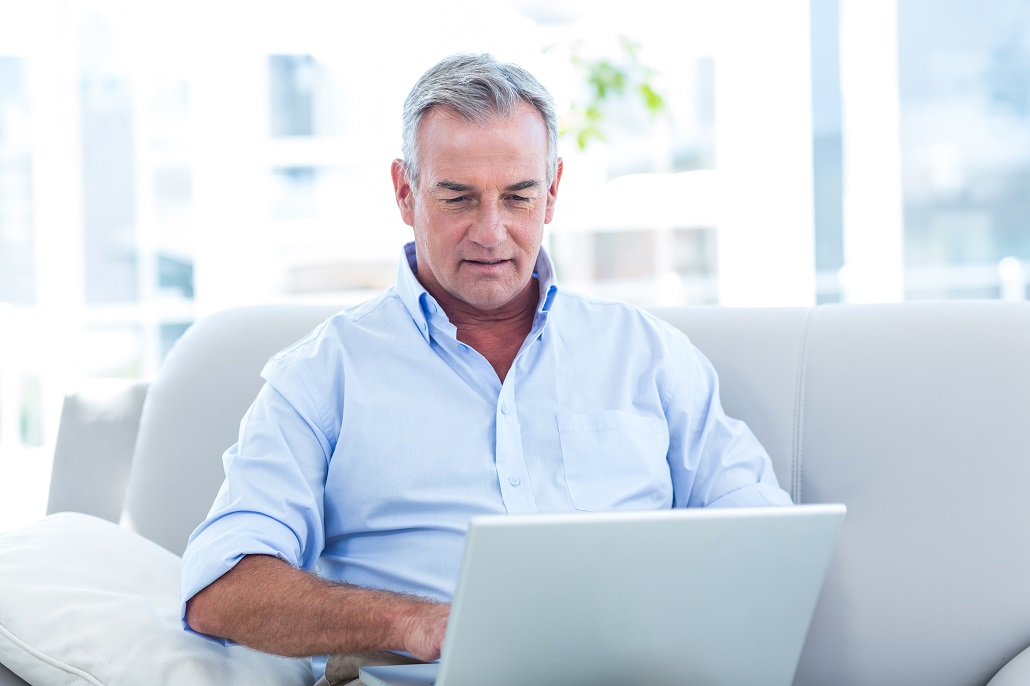 Man using laptop to apply for financial aid