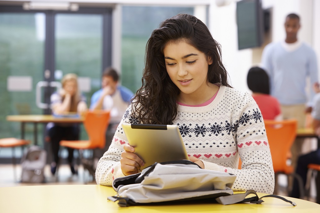 Student using tablet in cafeteria 