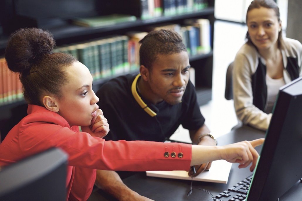 College students using computer to learn about college admissions for transfer students