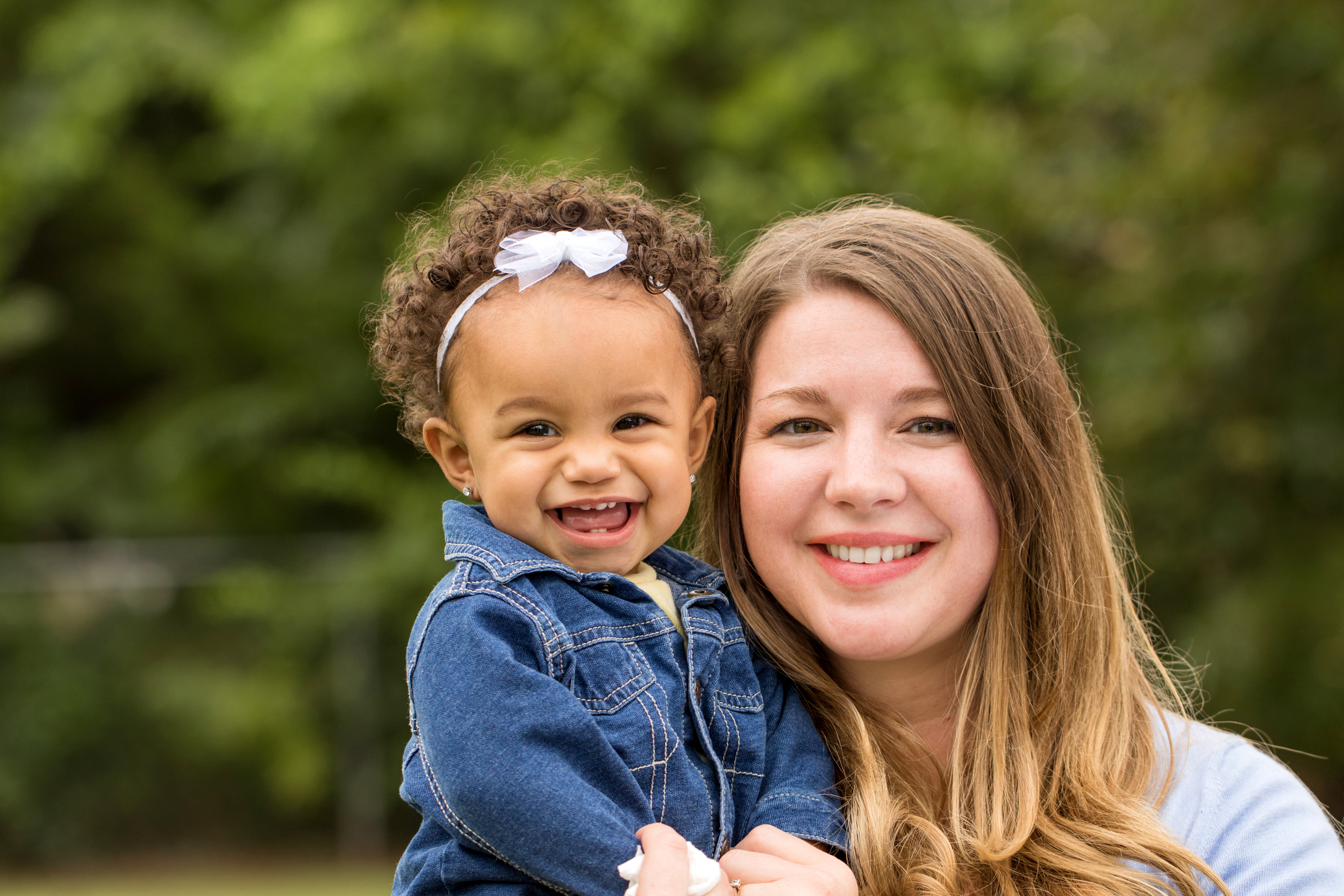 Mother holding young daughter planning to save for college