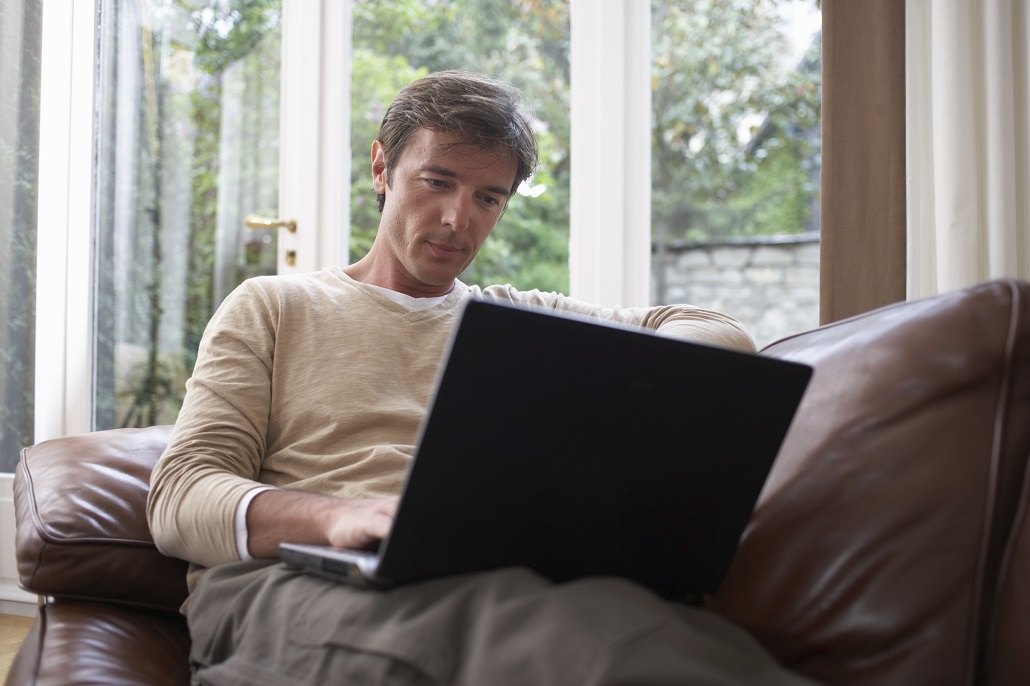 Man using laptop to learn about financial aid