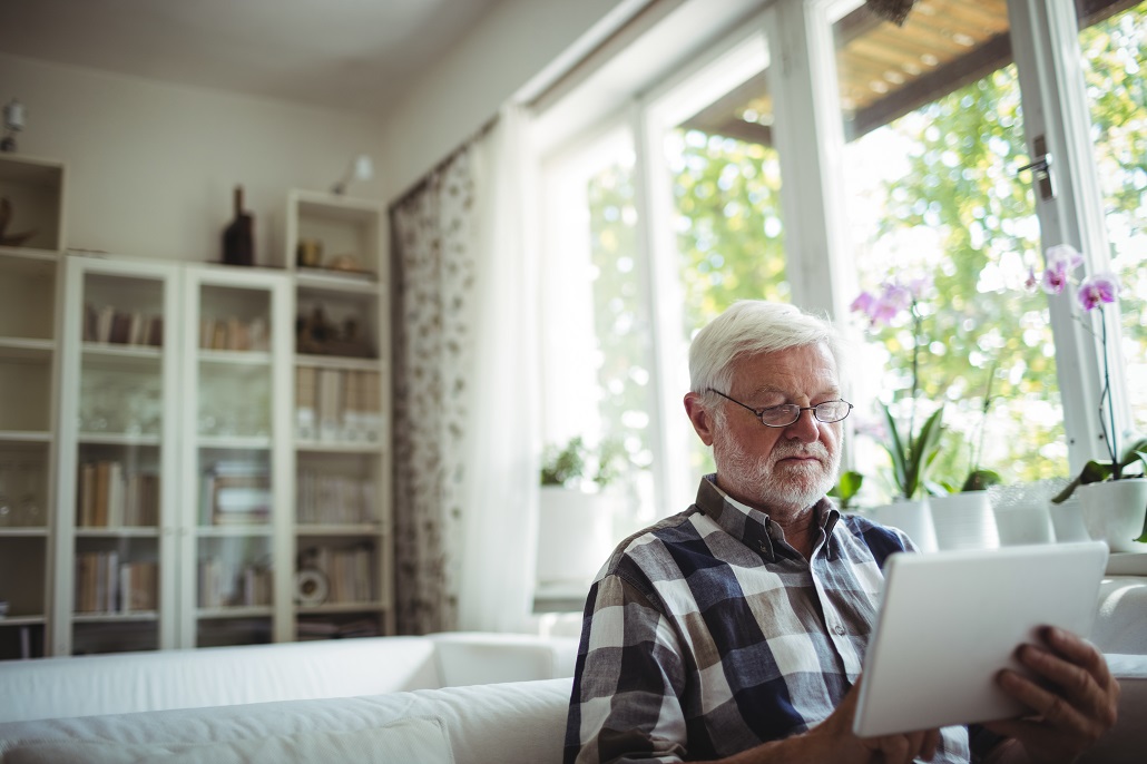 Man using tablet to review U.Plan tax paperwork