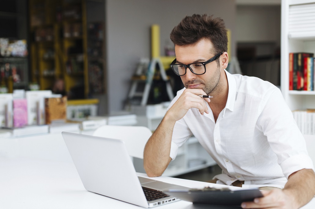 Man using laptop to learn about Adjusted Gross Income