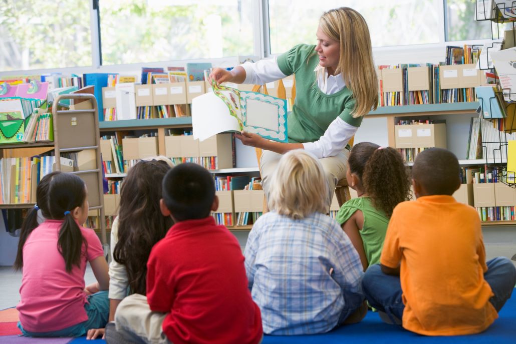 Woman reading a book to children at a Start U.Reading event