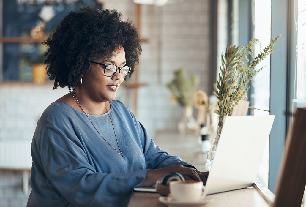 Woman using laptop to purchase tuition insurance