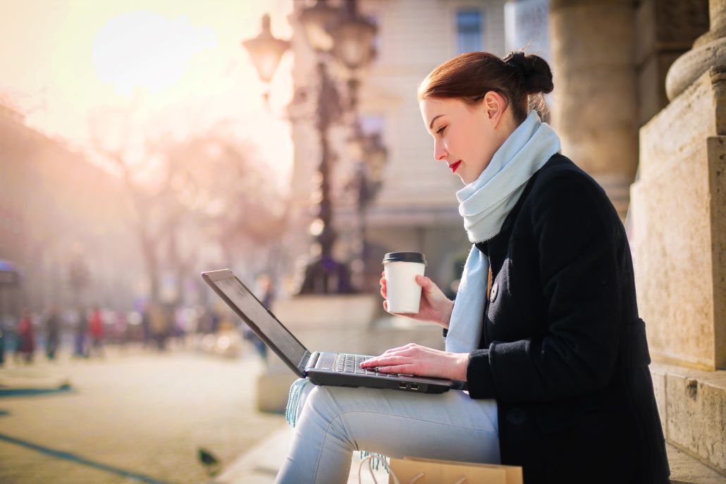 Woman using laptop on steps 