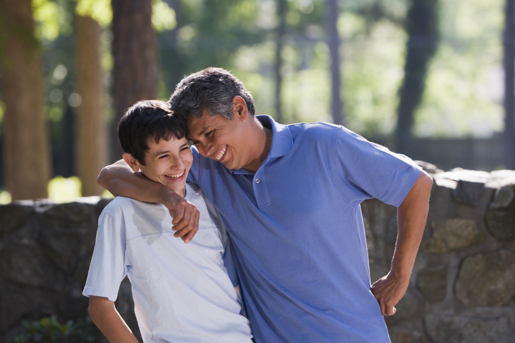 Father and son standing outside