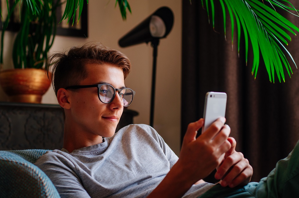 Student using phone to learn about post-graduate programs