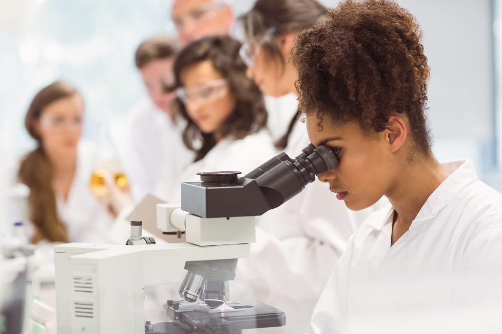 Student using a microscope in class