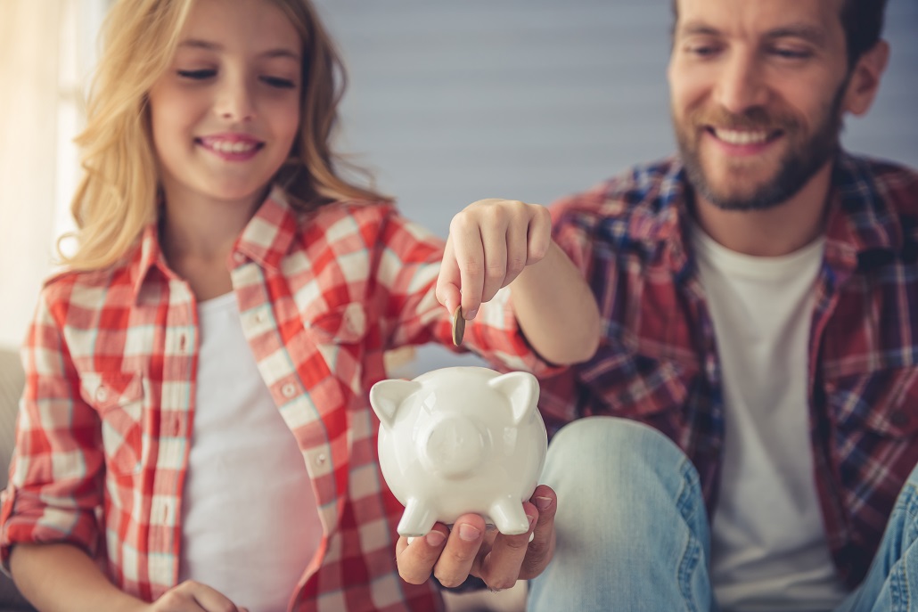 A family saving for college with a piggy bank
