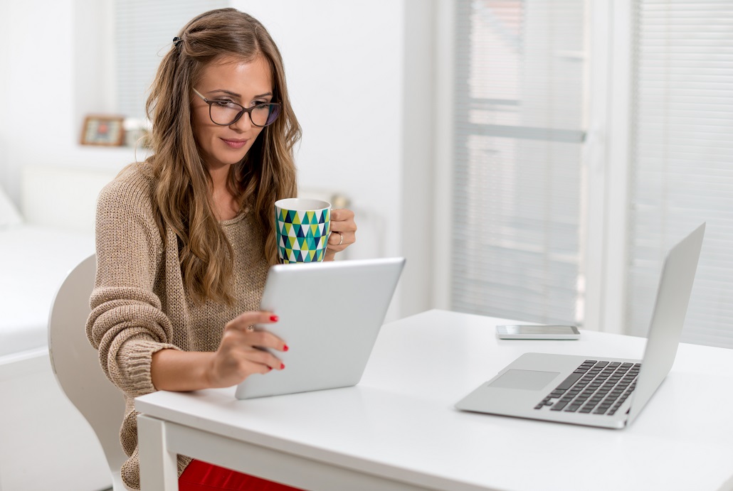 Woman using tablet to figure out how much her MEFA Loan will cost