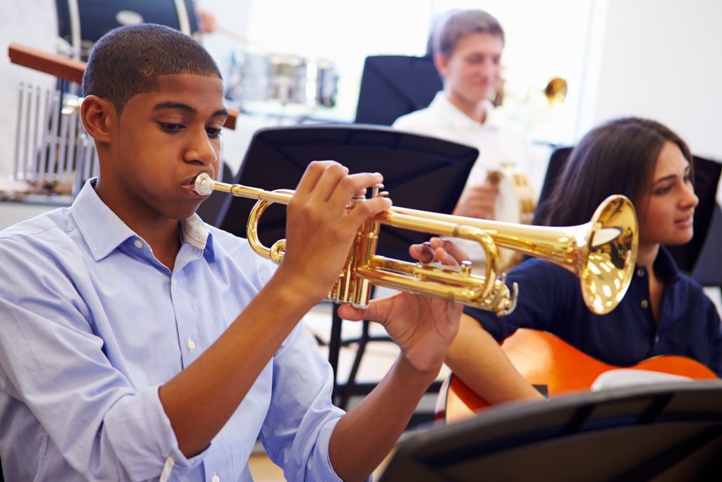 Student playing a saxophone during a college audition