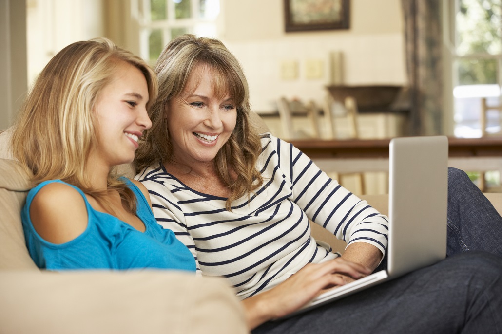 Mother and daughter using laptop together