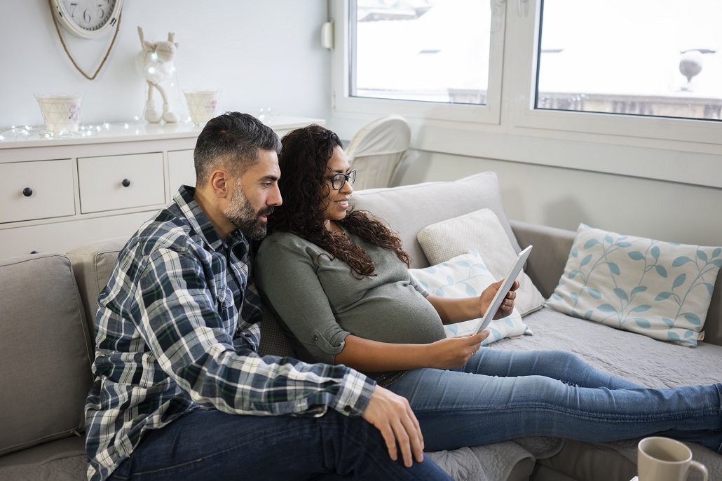 Parents using tablet to learn about 529 accounts and Roth IRAs